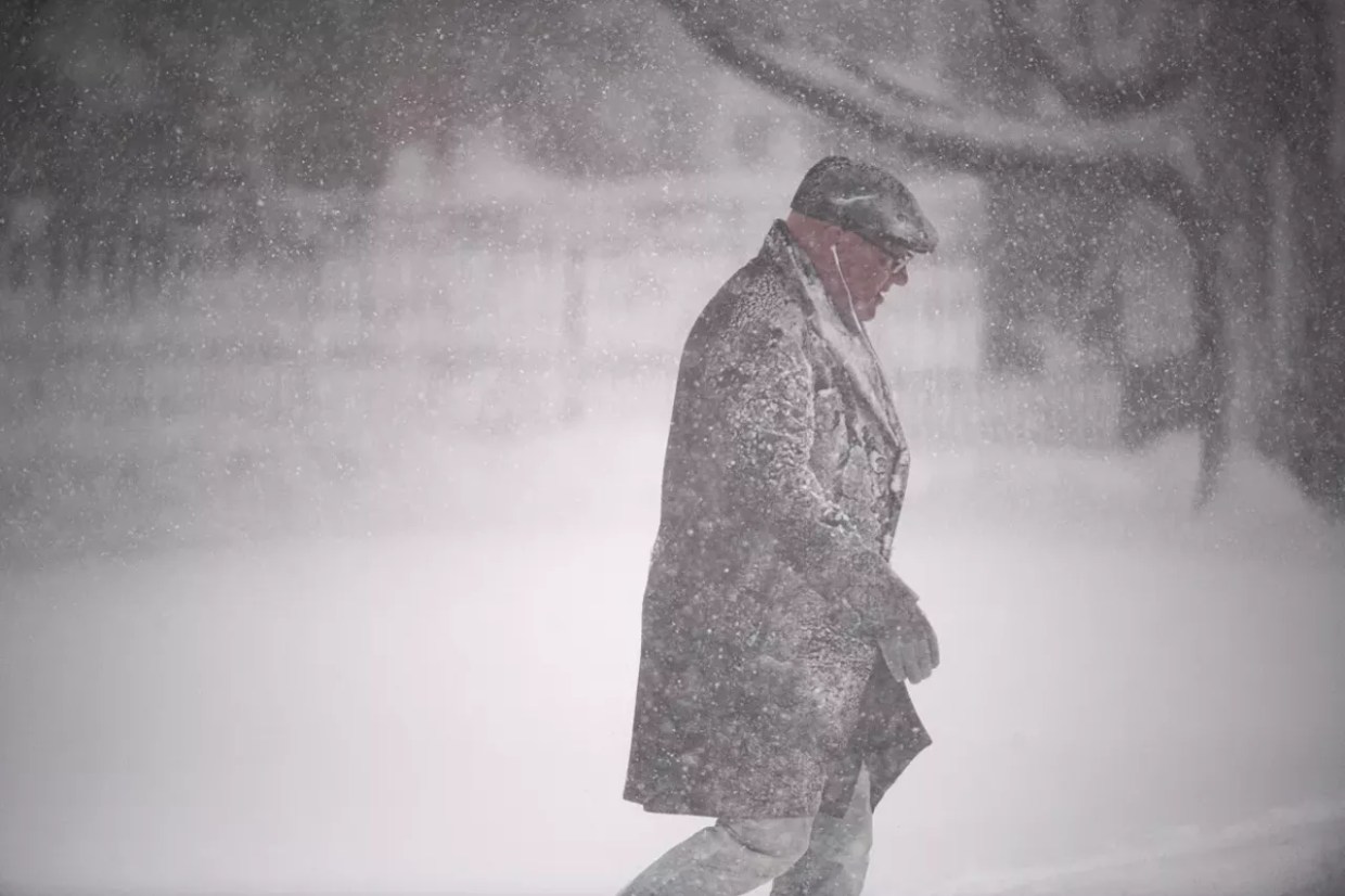 Man walks to Denver bus stop during blizzard