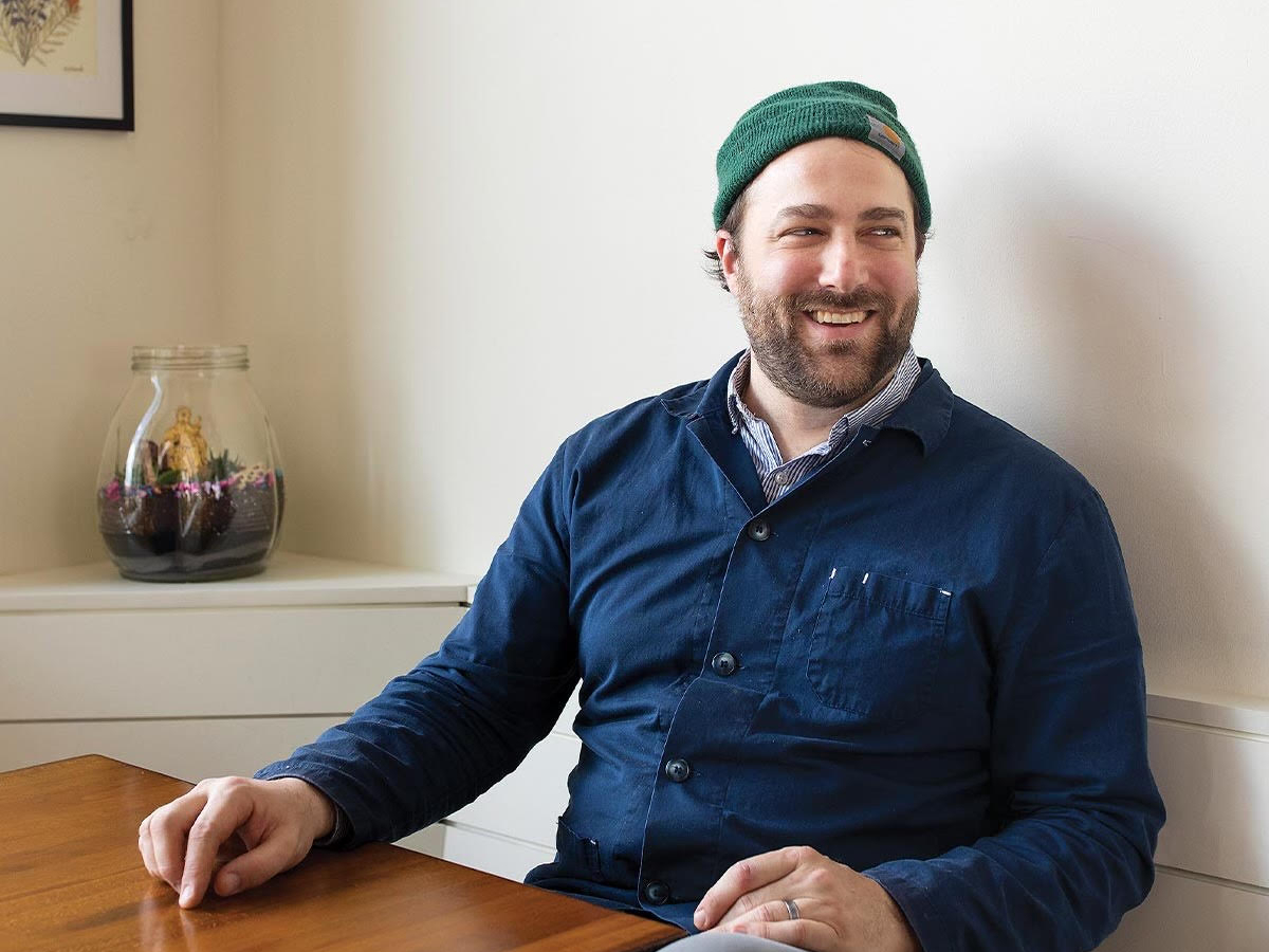 man in a blue shirt and beanie