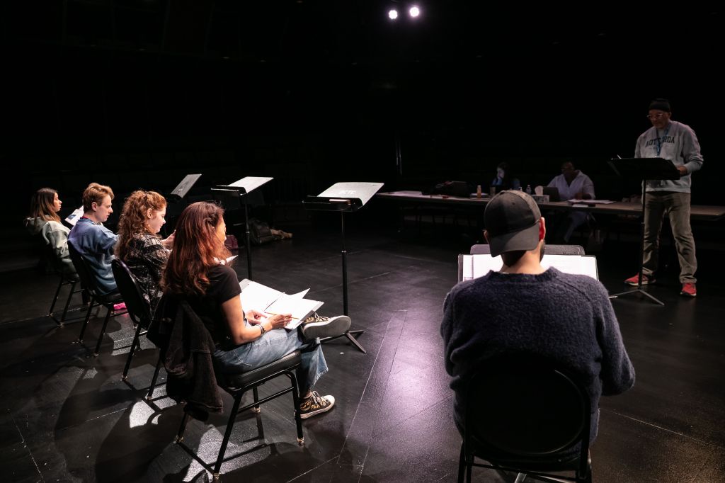 A rehearsal room filled with actors
