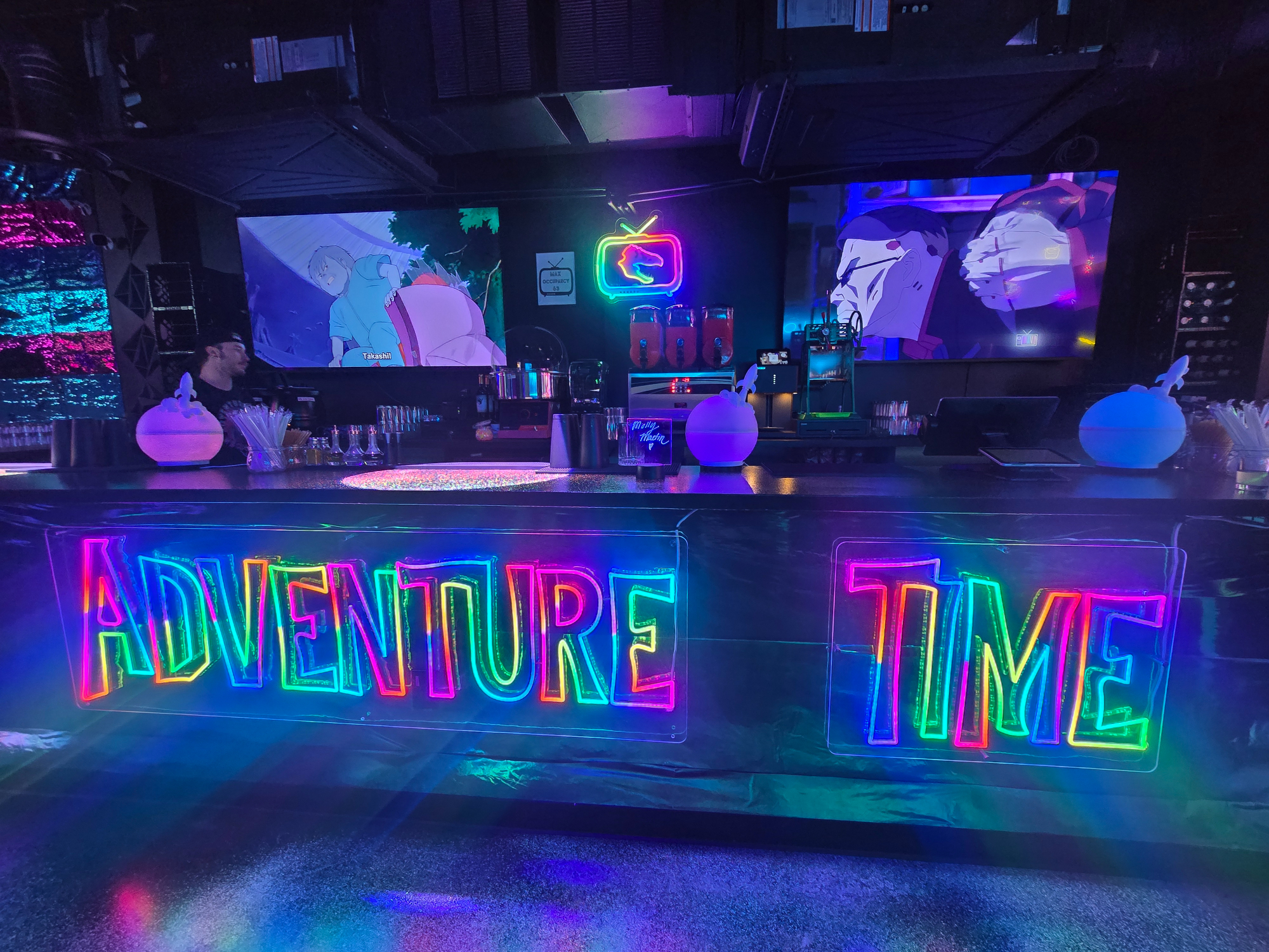 bar with neon "adventure time" lights