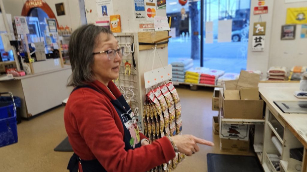 woman wearing an apron in a grocery store