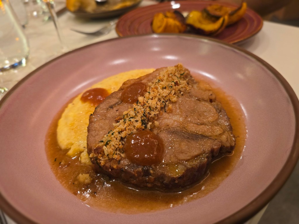 pork dish on a pink plate