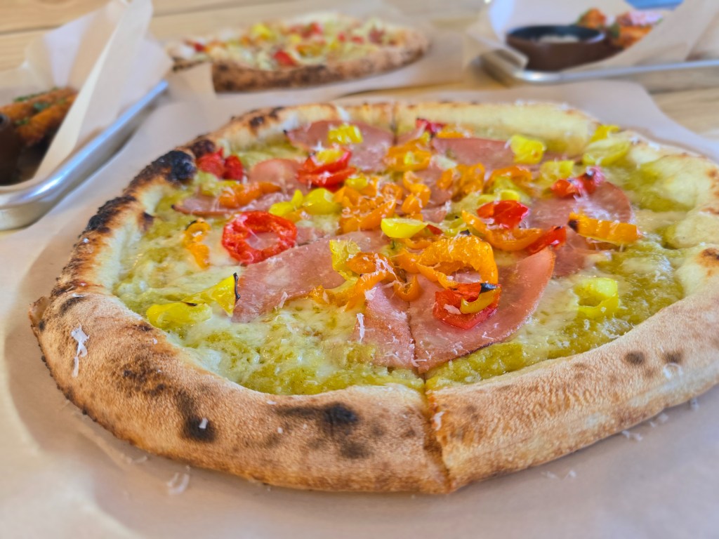 pizza topped with mortadella and peppers