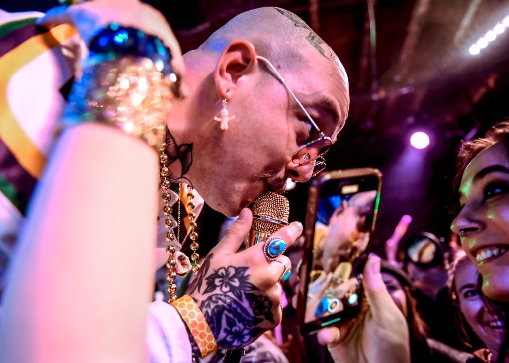 man singing into mic to an audience member