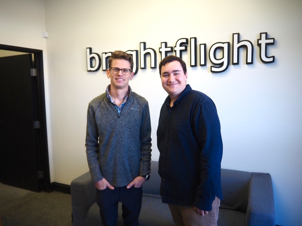 two men stand together