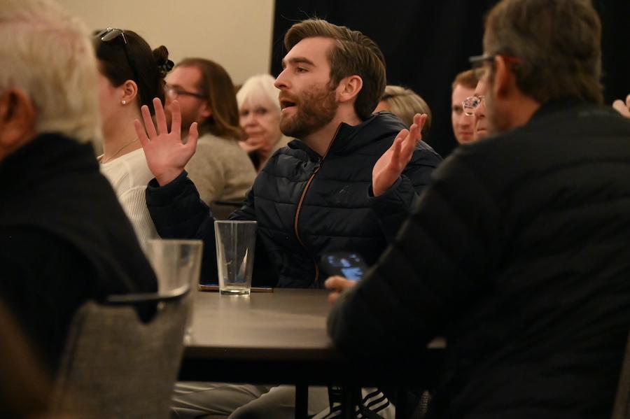 man speaks during town hall