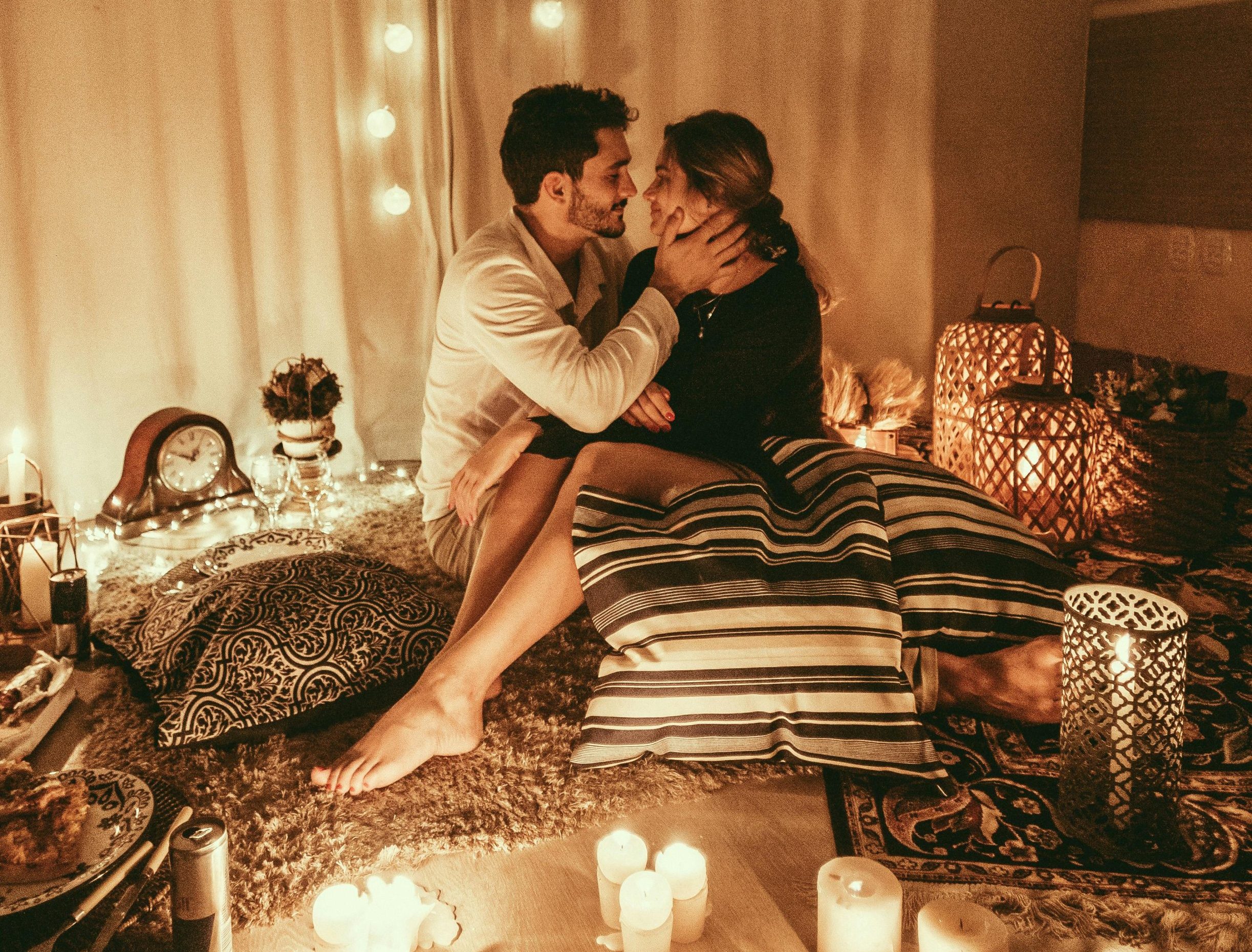 People hooking up on a bed