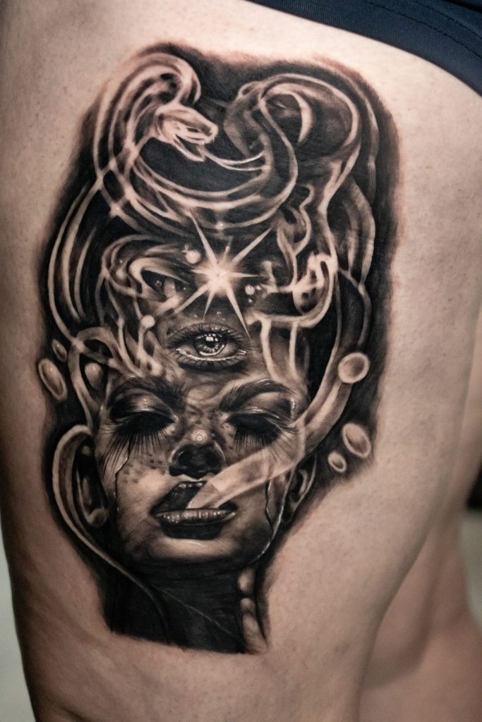 a black and white tattoo of a face