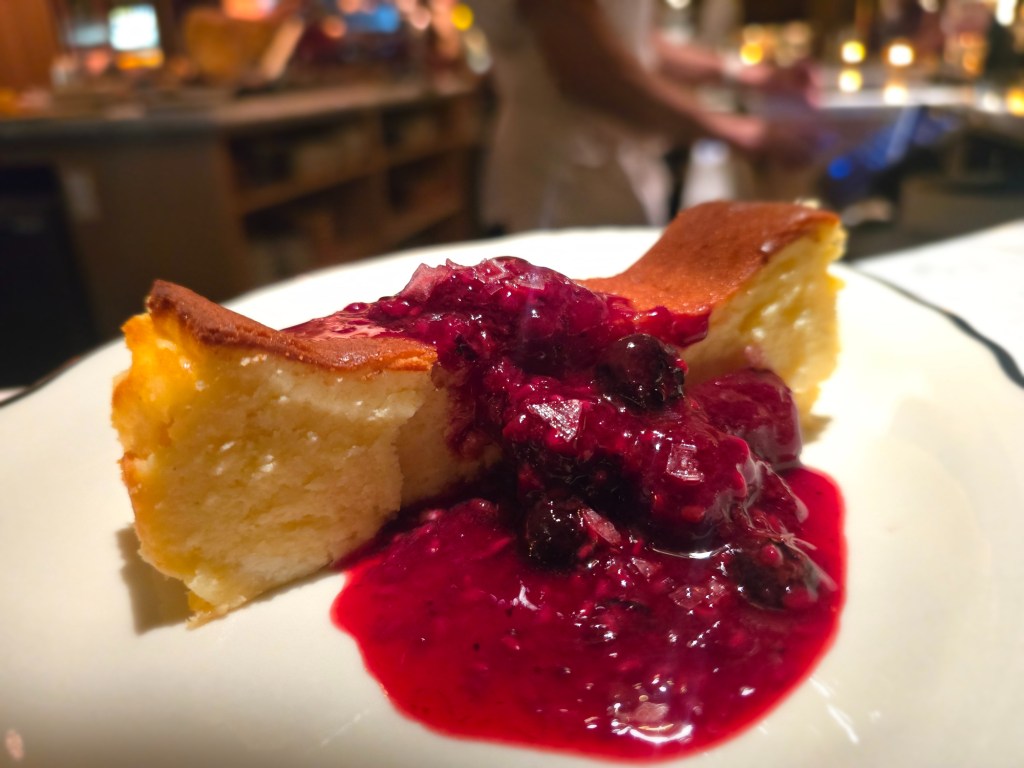 slice of cheesecake with berry sauce