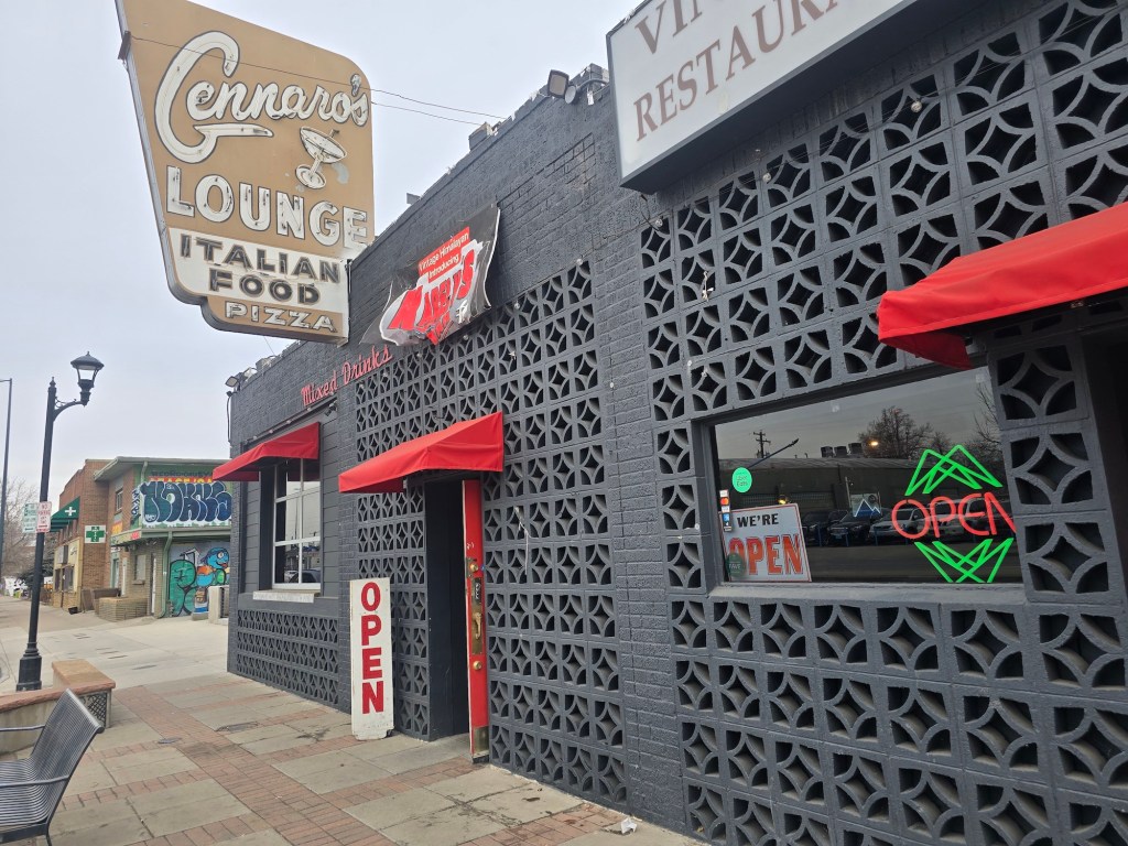 "open" sign in front of a black building