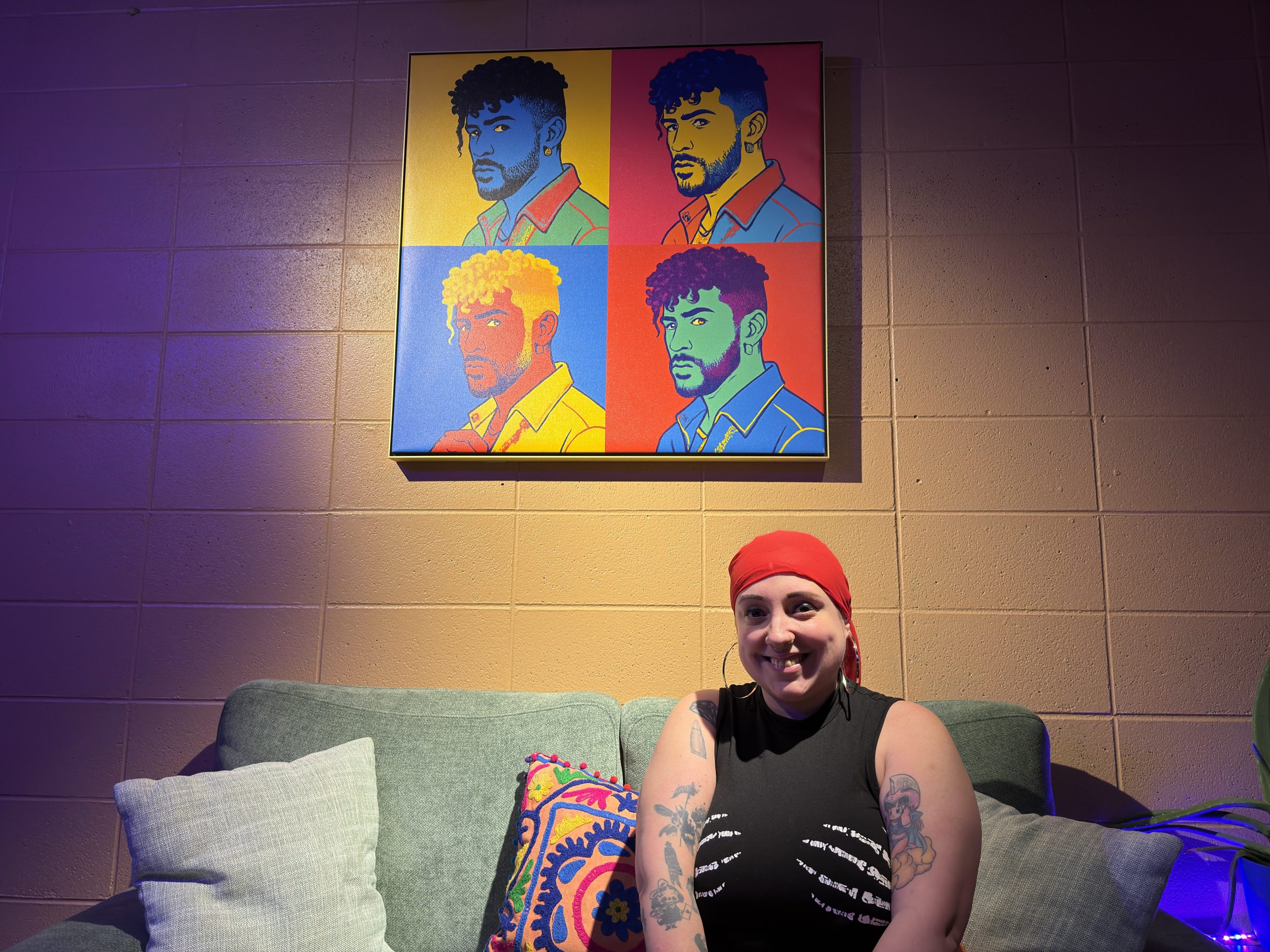 a woman posing beneath a portrait.