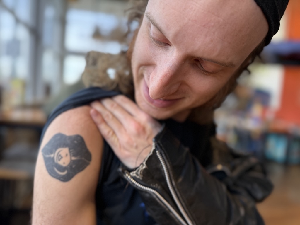 a man showing off a tattoo