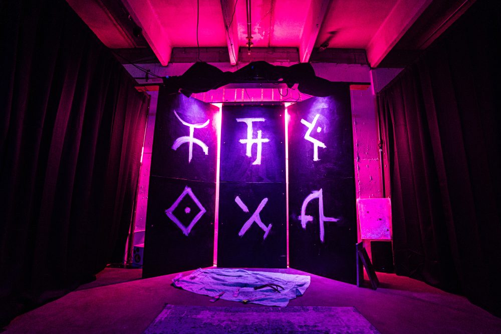 Mysterious symbols on panels in a pink-colored room