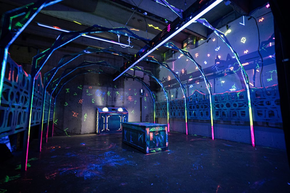 An unsettling room with glowing symbols on the walls