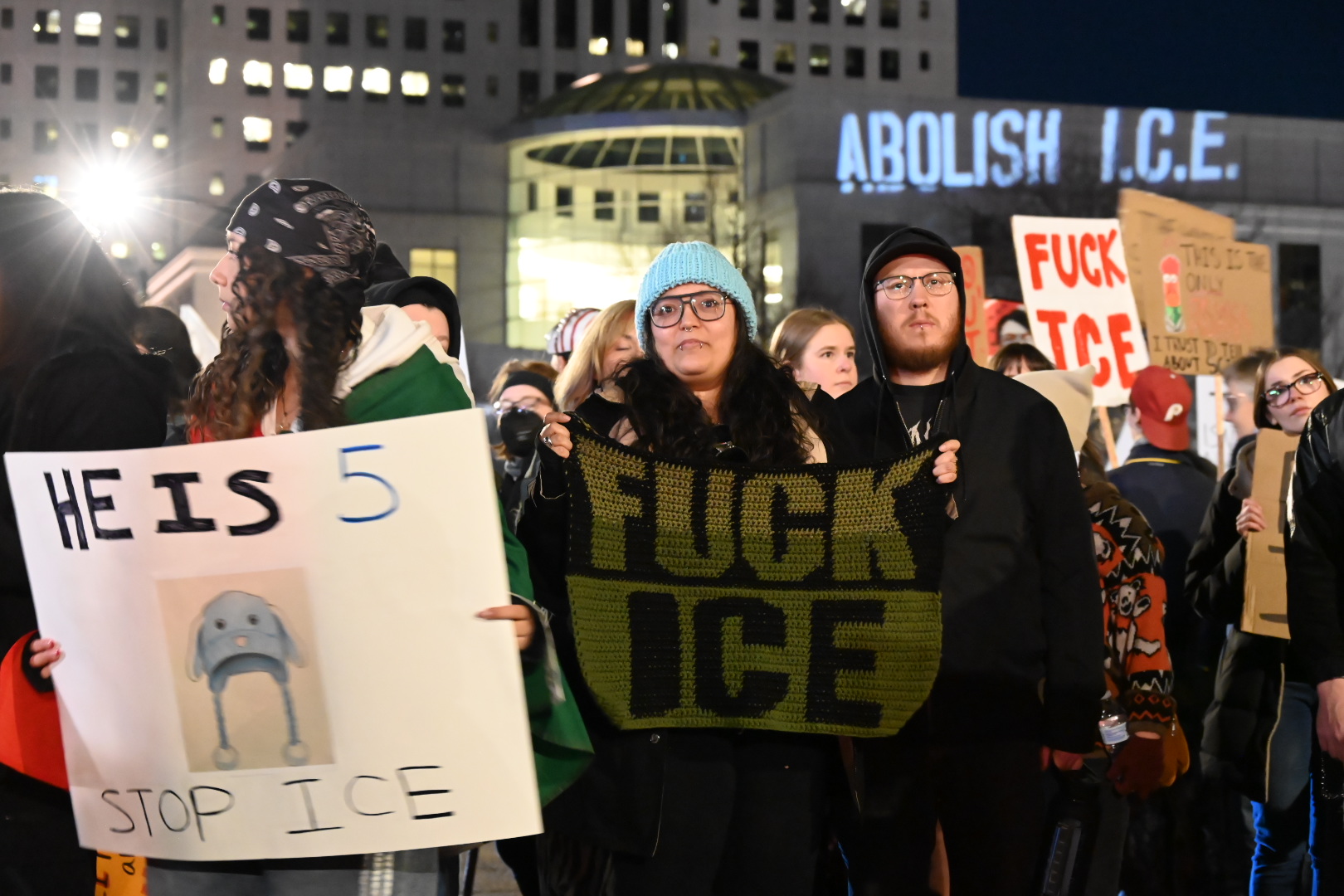 protesters gather at night in denver