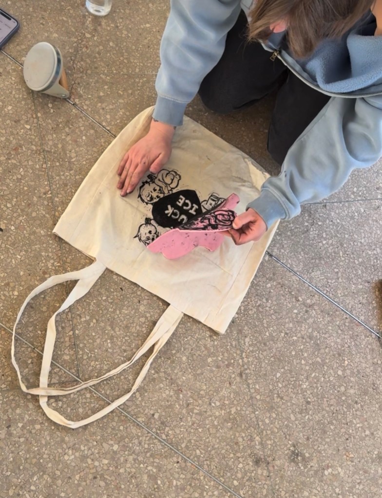 Mara Wroblewski printing her design on a tote bag at the Cheesman Park pavilion.