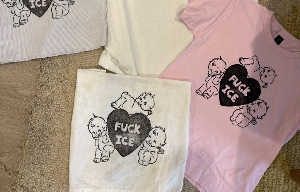 Clothing printed with a design of kewpies surrounding a heart that says "Fuck ICE"