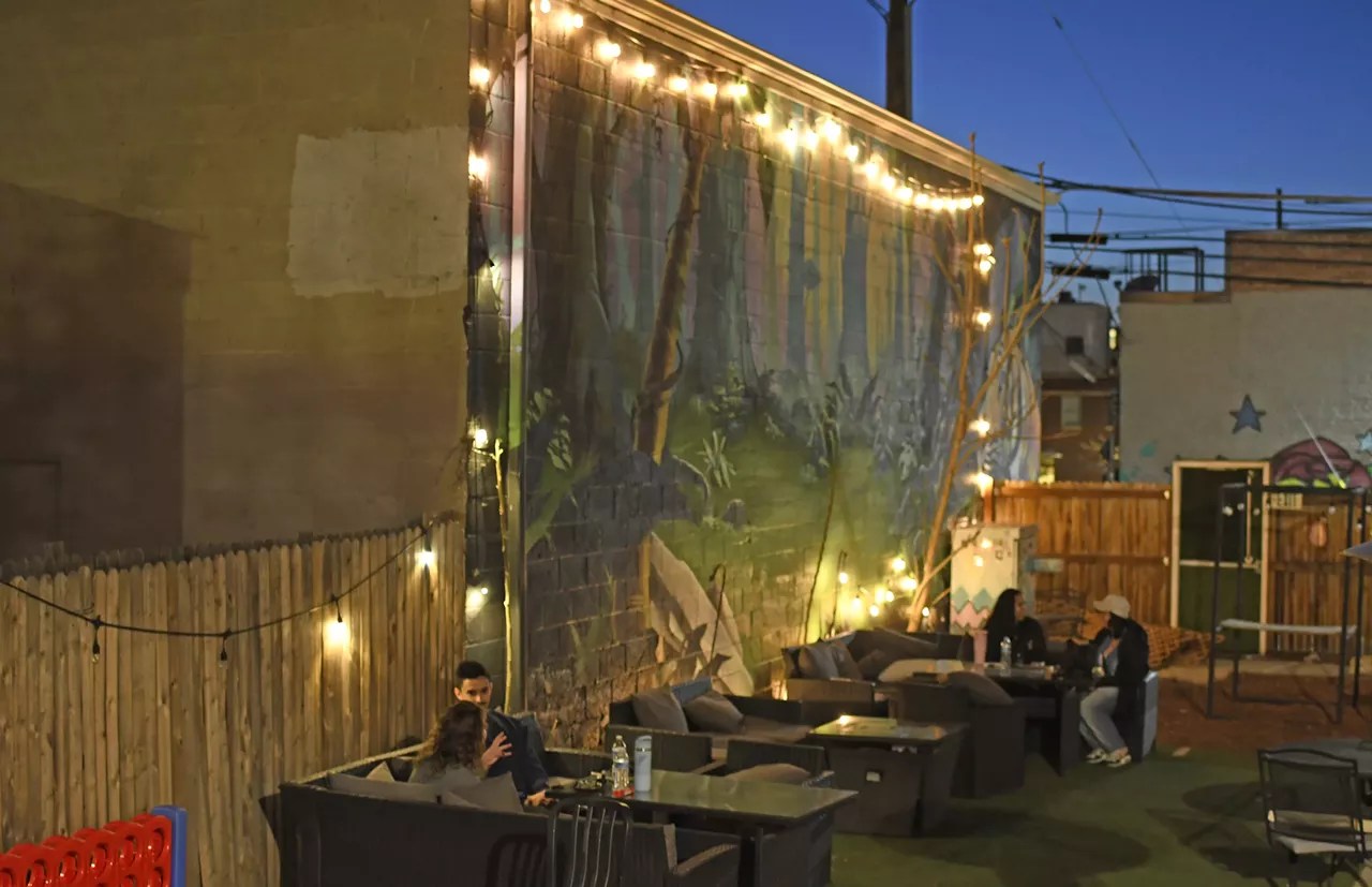 people sit outside on patio at night