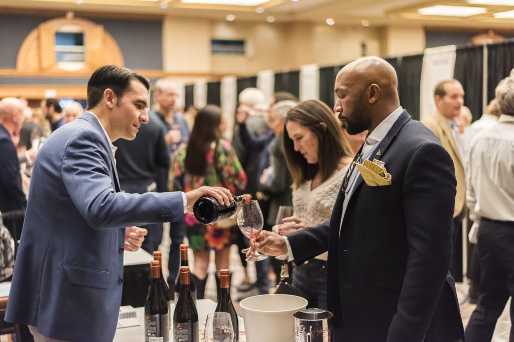 a man pouring wine