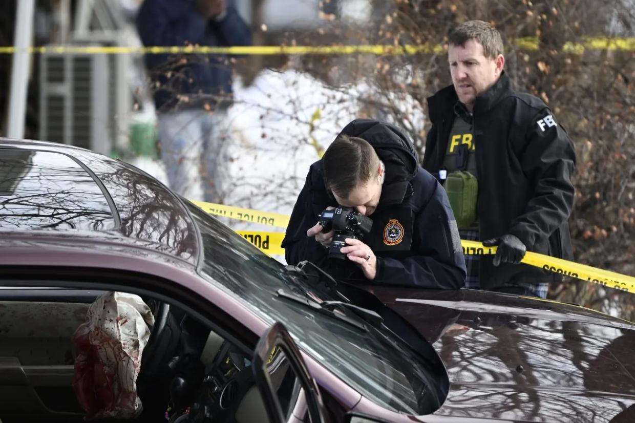 law enforcement officials looking in car