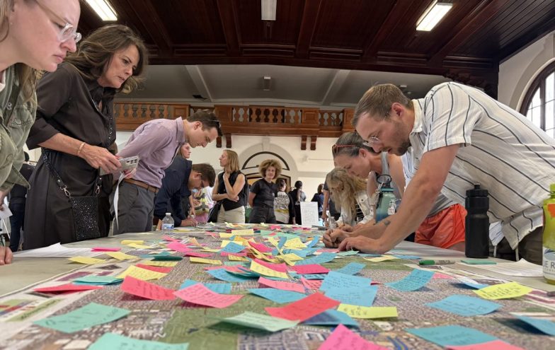 Residents put sticky notes on a map of Colorado Boulevard at CDOT's open house for the new Bus Rapid Transit project on May 13, 2026.