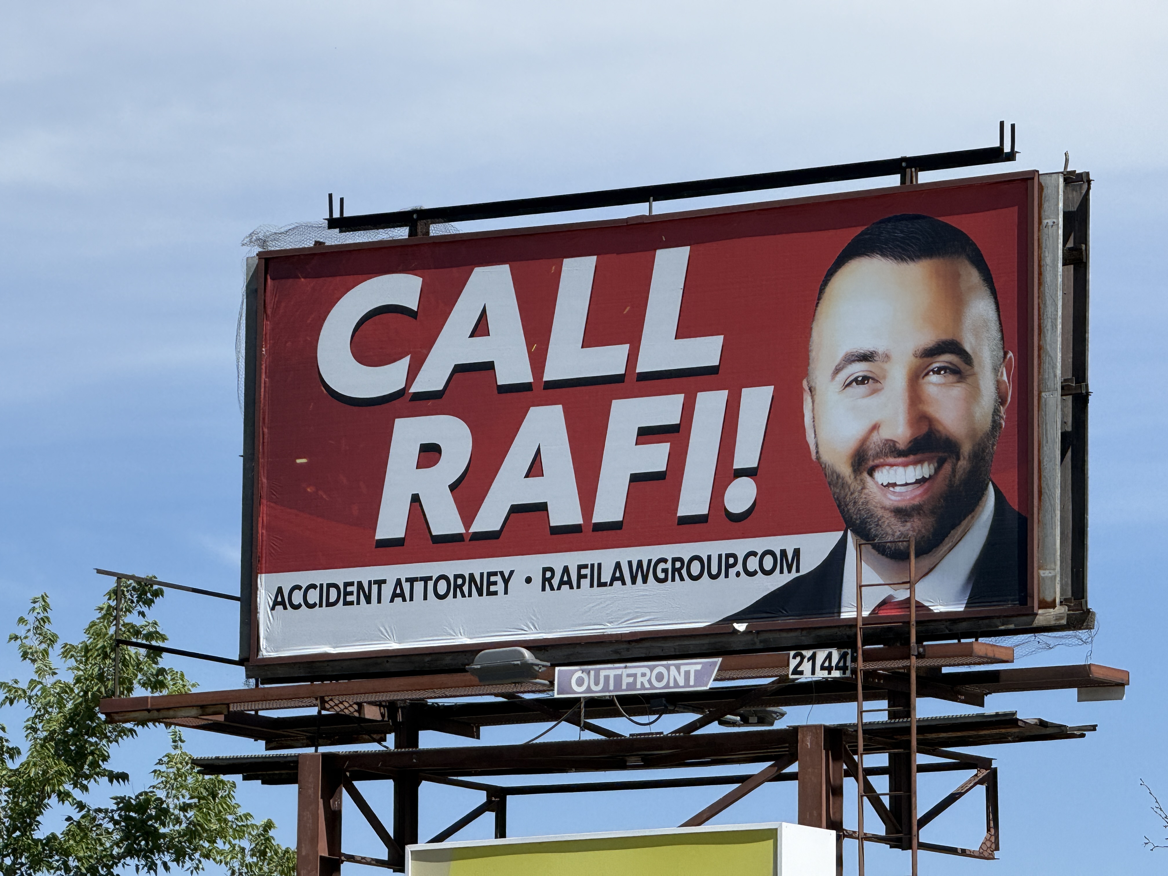 A "Call Rafi!" Rafi Law Group billboard in Denver