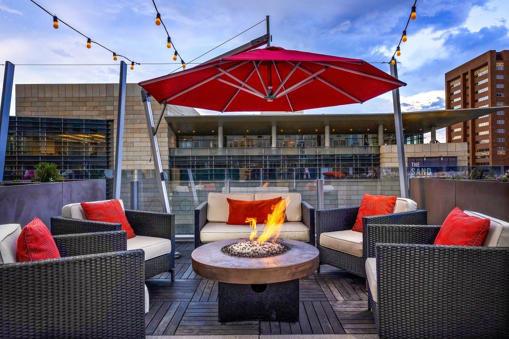 Lounge chairs surrounding a firepit on the Fire Restaurant rooftop