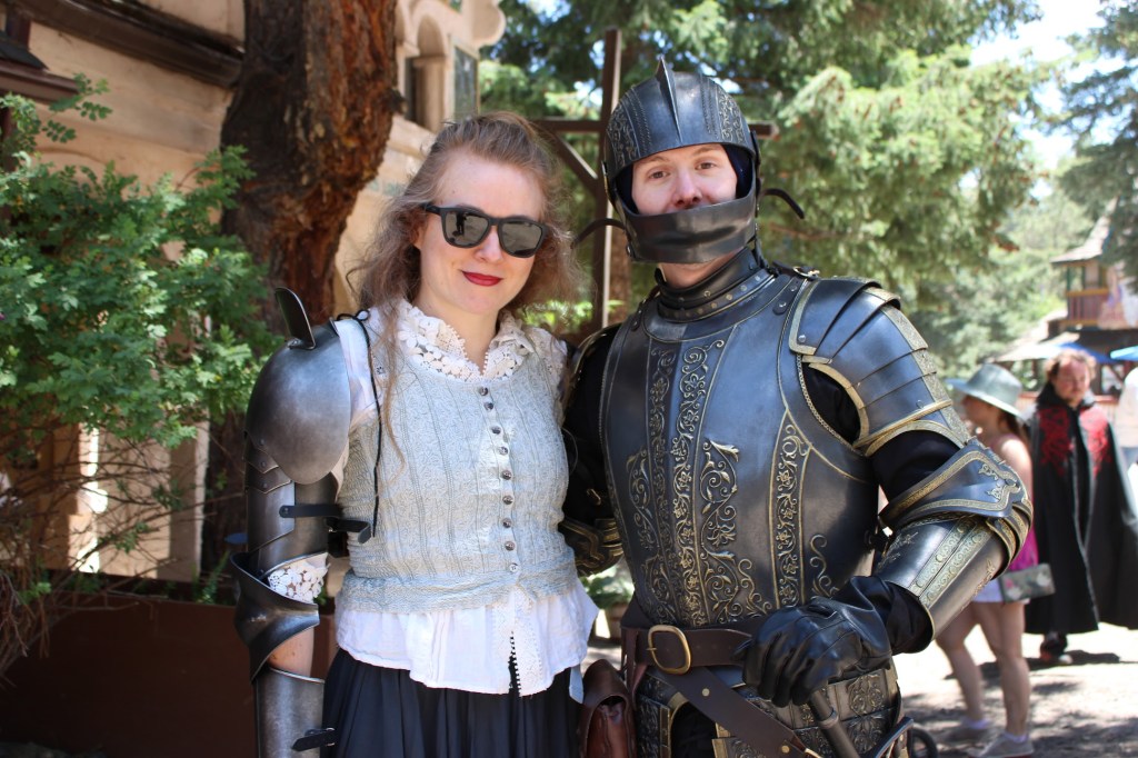 A couple pose in armor