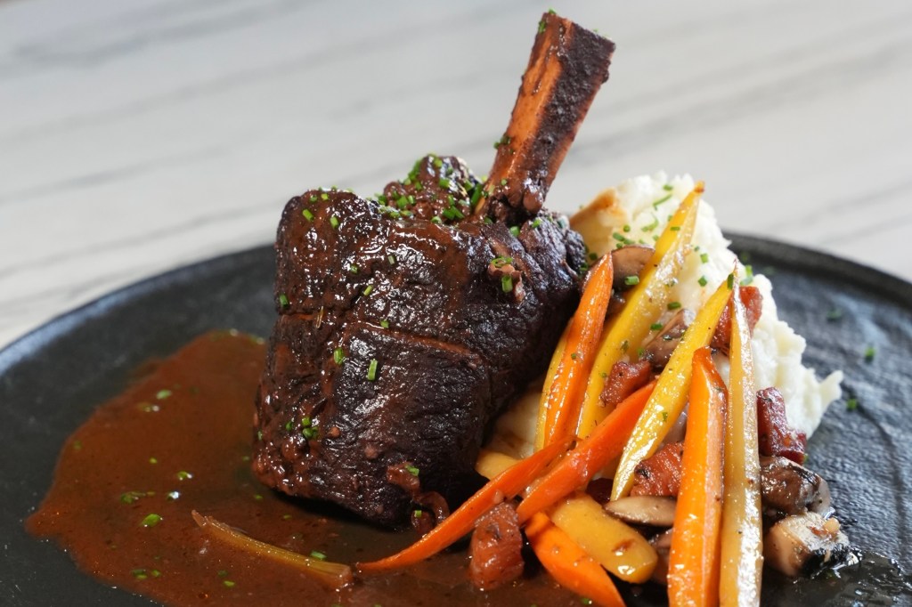 A prime rib dish served with carrots and mashed potatoes from Jacks