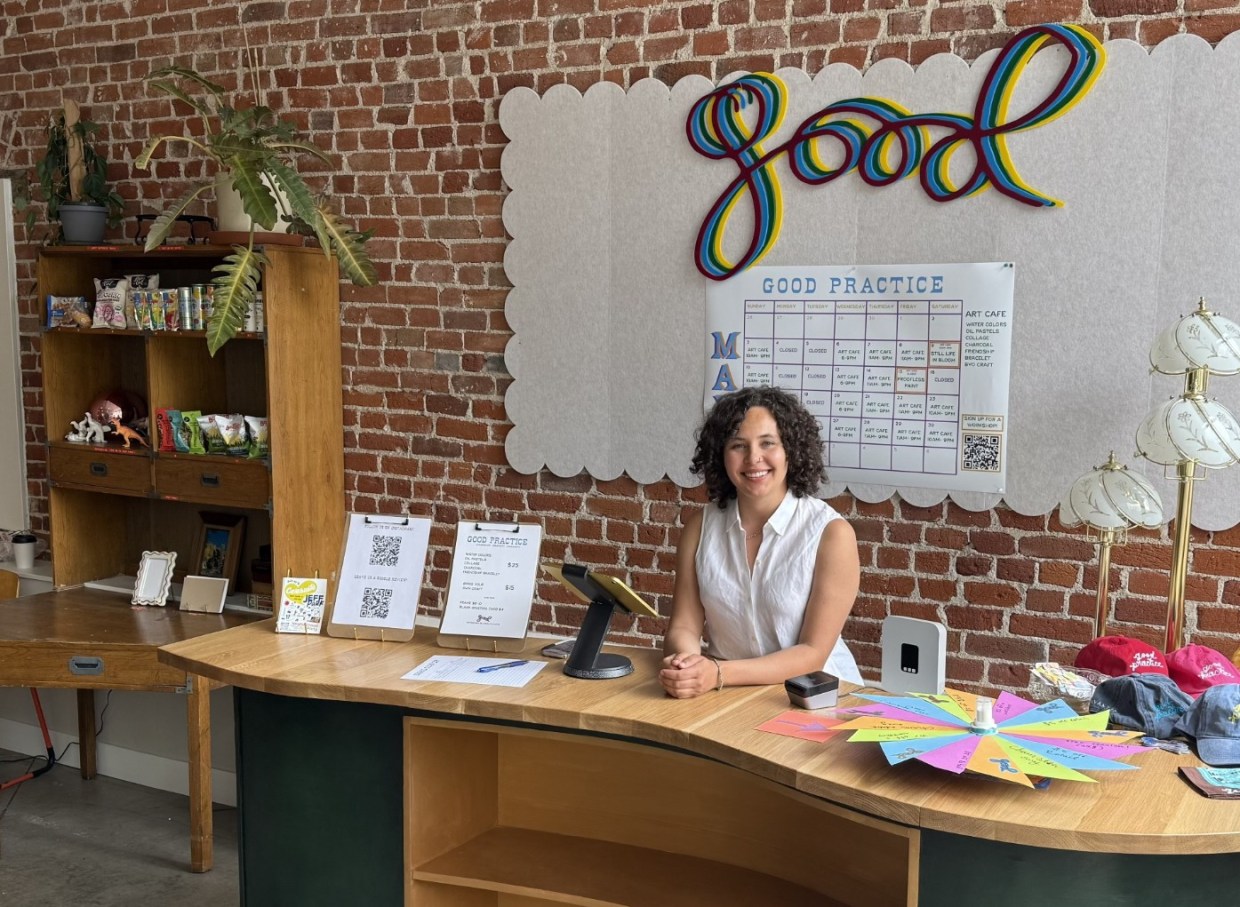 A woman at the counter of an art cafe