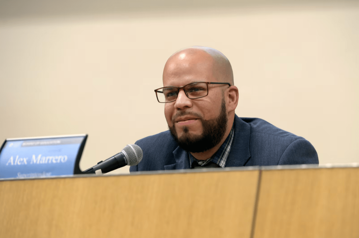Denver Public Schools Superintendent Alex Marrero listens to students at a school board meeting