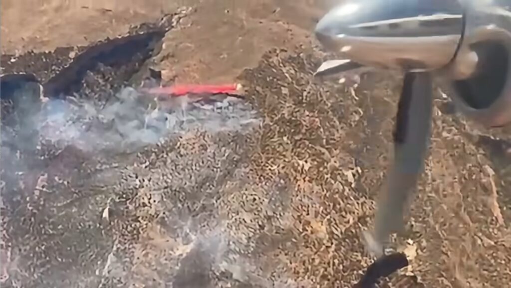 A plane drops fire retardant as firefighters respond to a series of lightning-caused fires along the Utah-Colorado border.