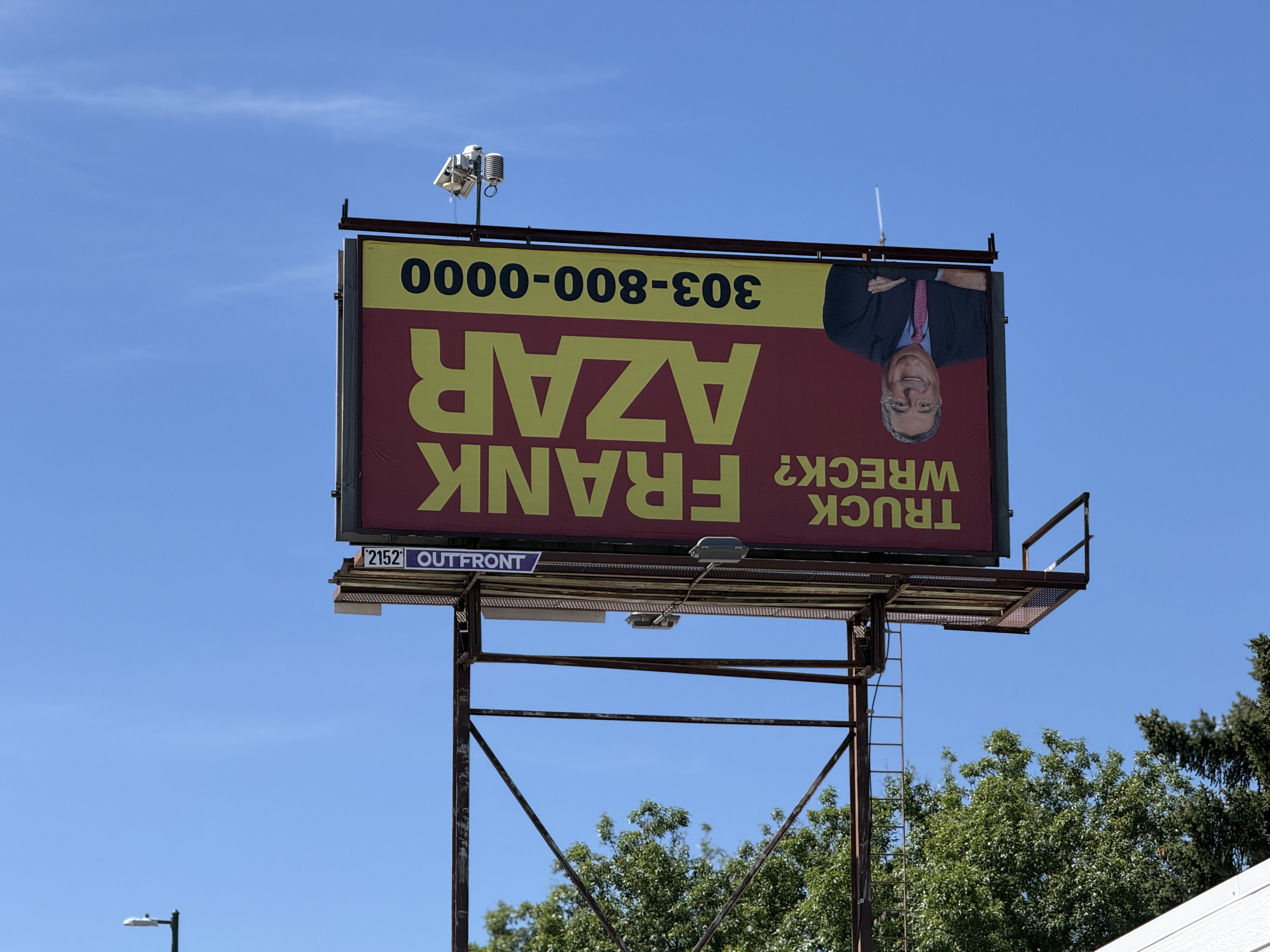 An upside billboard for Frank Azar in Denver