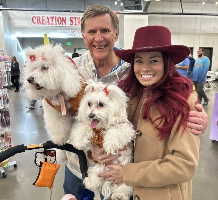 People holding white dogs