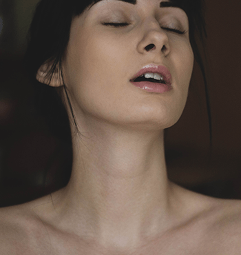 A woman who appears to be experiencing pleasure.