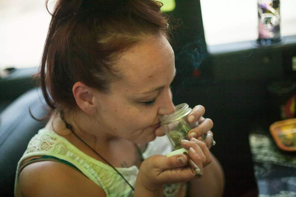 woman smells jar of weed