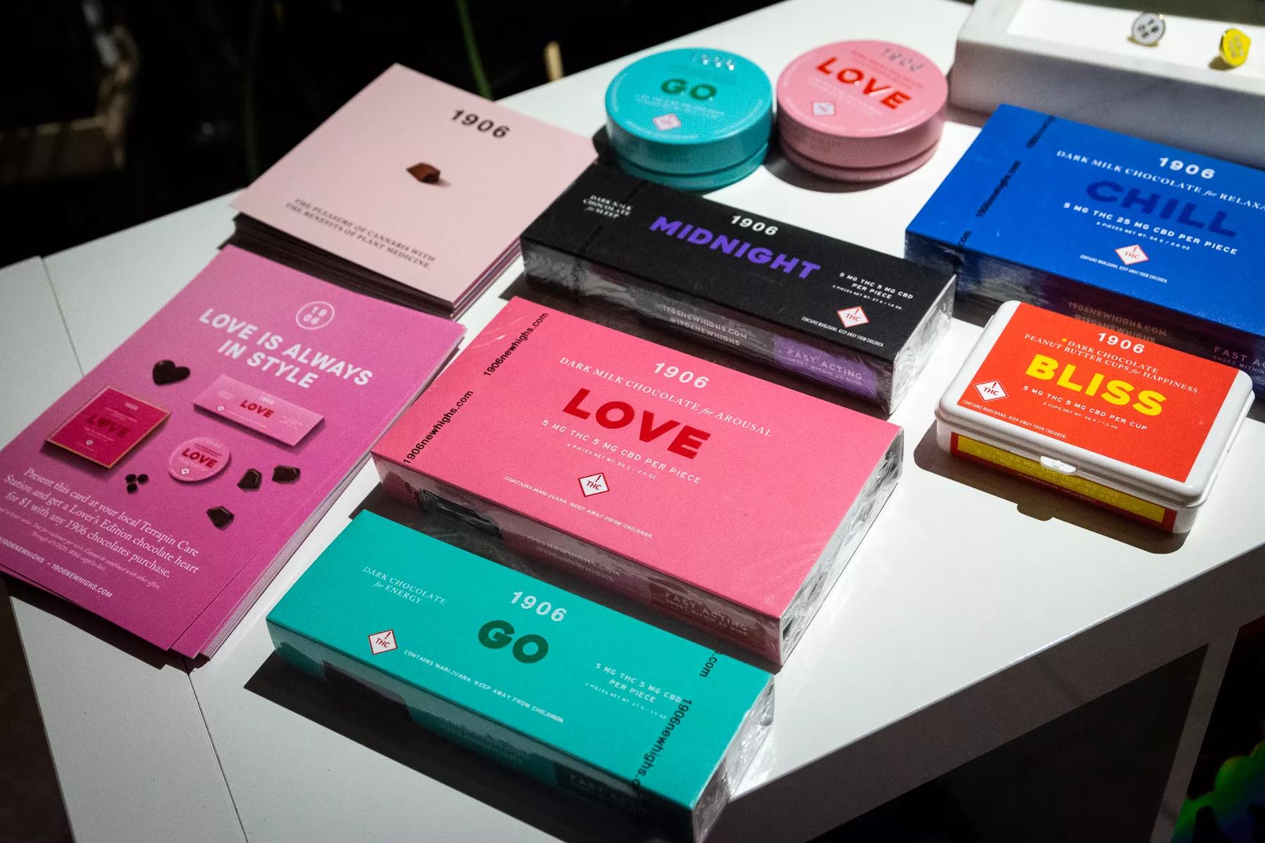 A table full of 1906 cannabis edibles in colorful boxes