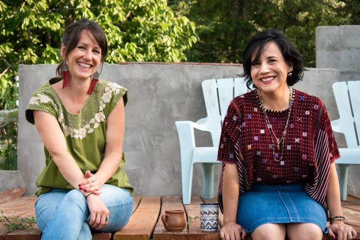 two women sitting outdoors