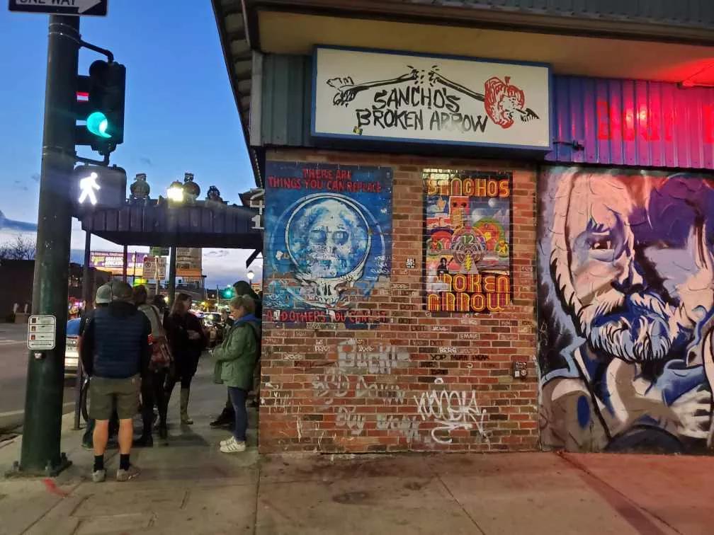 a brick wall with graffiti and street art