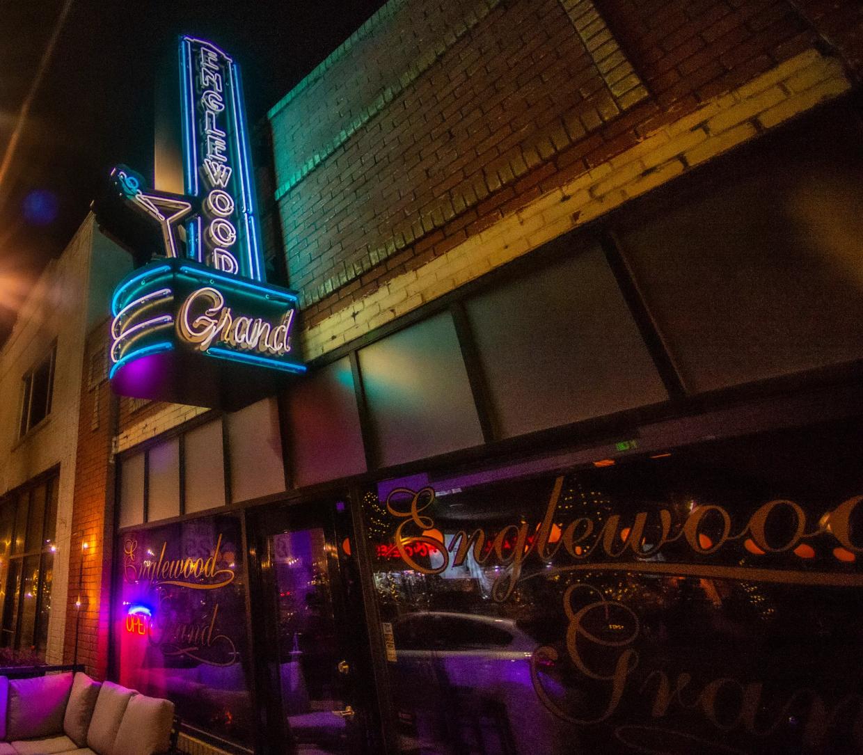 glowing sign in front of a bar