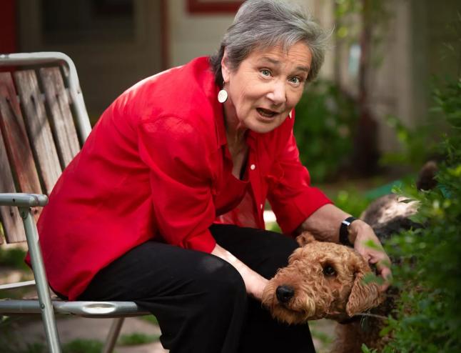 woman in red sweater with dog