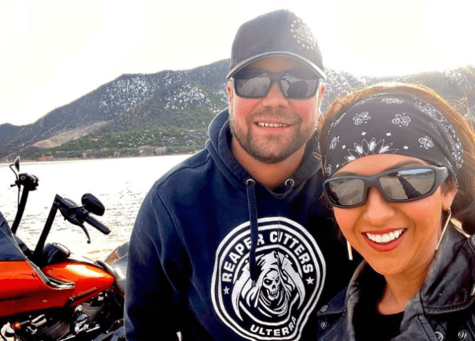 Congresswoman Lauren Boebert and her husband Jayson Boebert in an Instagram photo standing next to a motorcycle.