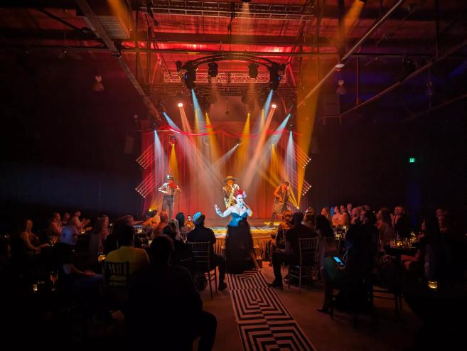 cabaret performers stand on a stage