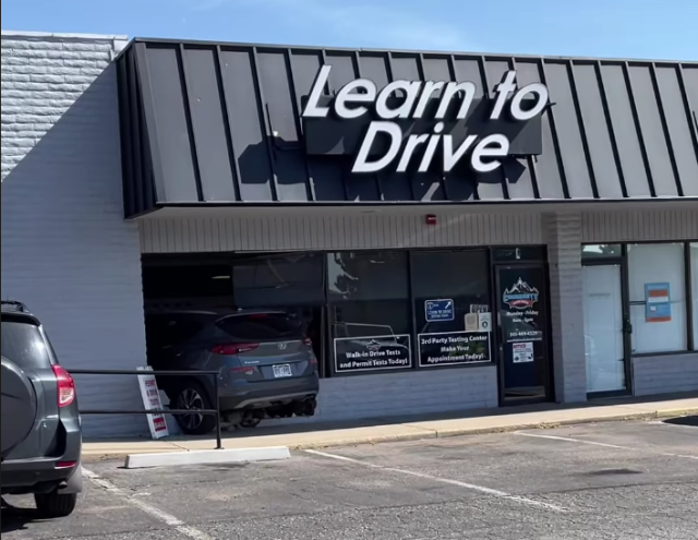 Community Driving School in Lakewood with car through window.