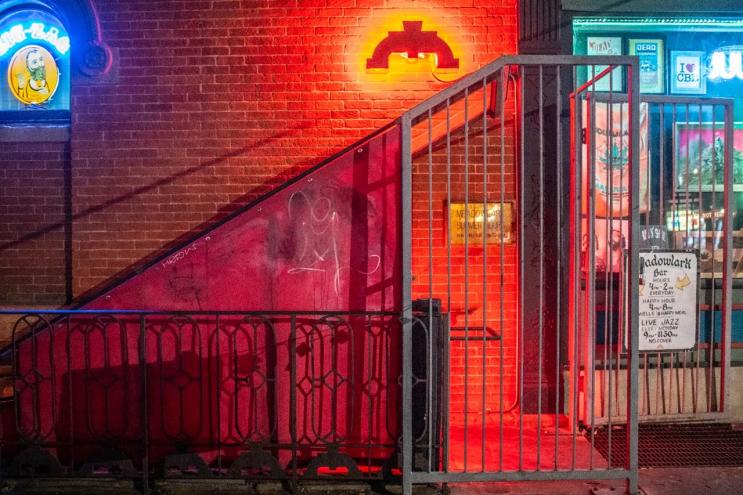 entrance to a basement bar with red light