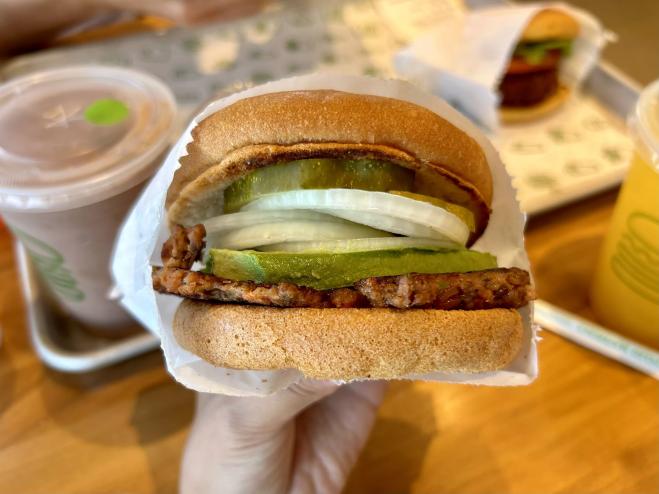 hand holding a hamburger
