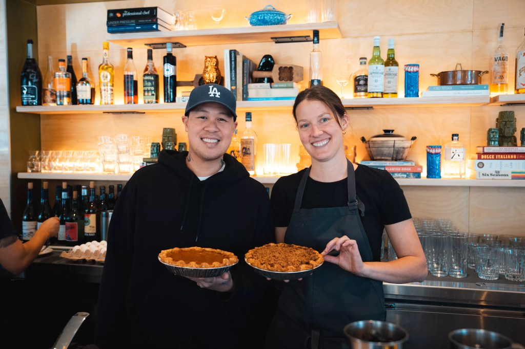 two people holding pies