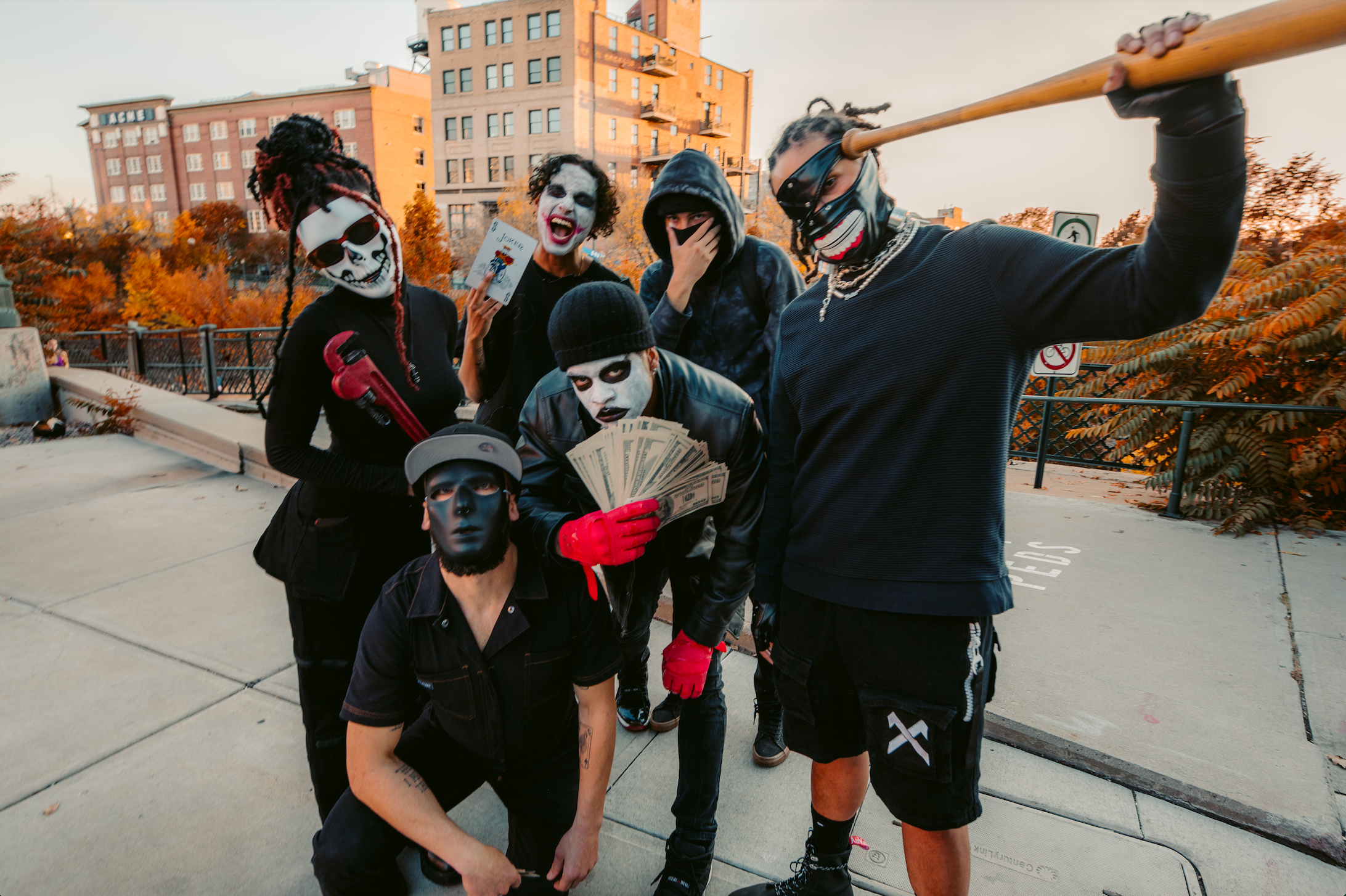 rappers dressed as clowns pose in a parking lot
