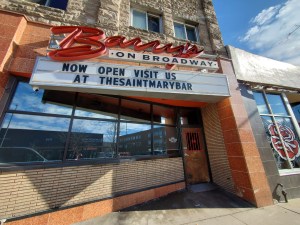 a retro sign with a marquee outside of a bar