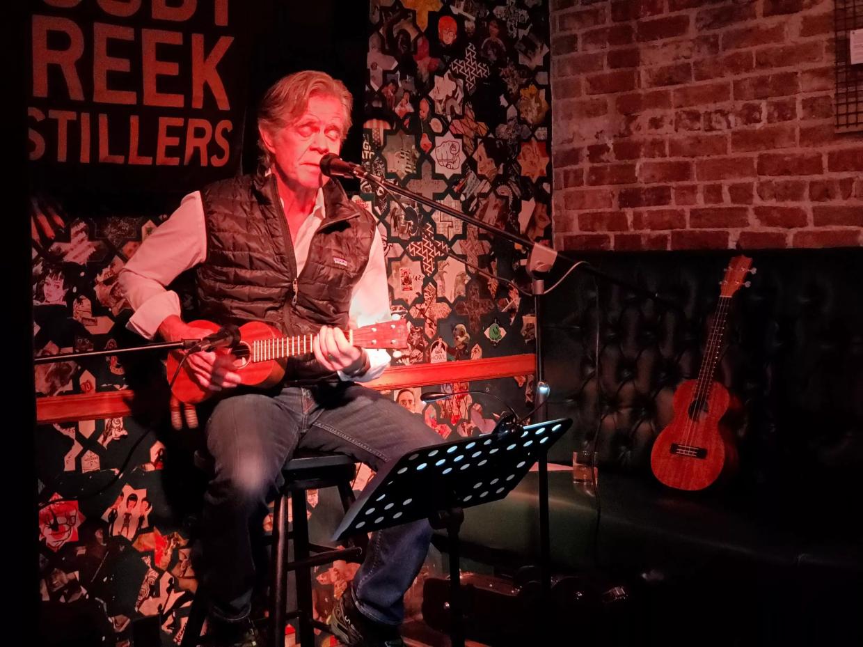 man playing ukulele